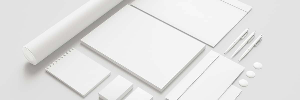 Blank white business stationery including notepads, envelopes, pens, flyers, brochures and posters