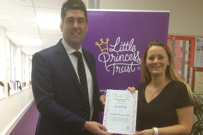 Two people holding a little princess trust certificate