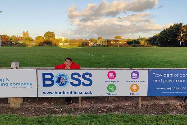 A little boy taking a photo representing the BOSS banner