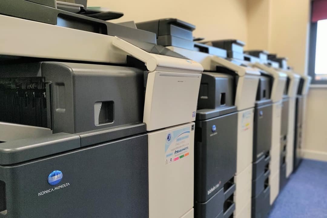 Multiple office large printers lined up