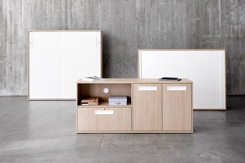 A grey room with office storage, with a few drawers and cabinets