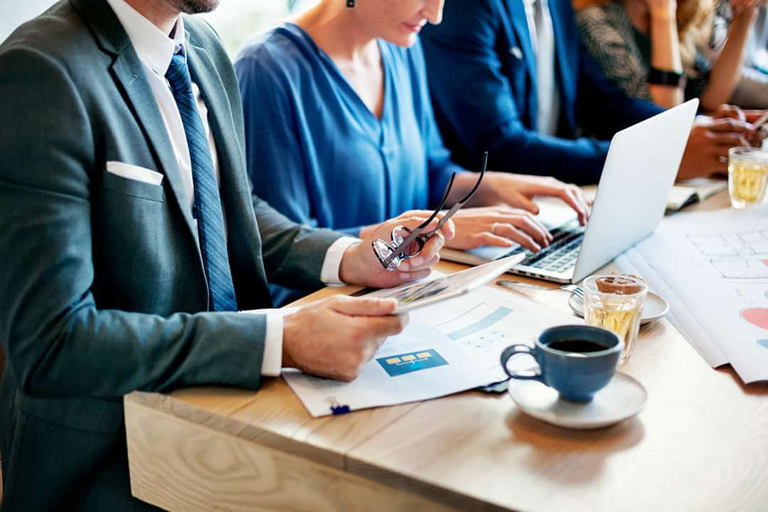 Businessman holding business documents at meeting table