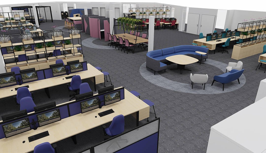 Very large open office with a range of blue, purple, pink and red chairs and different desks. Few shelves with plants on