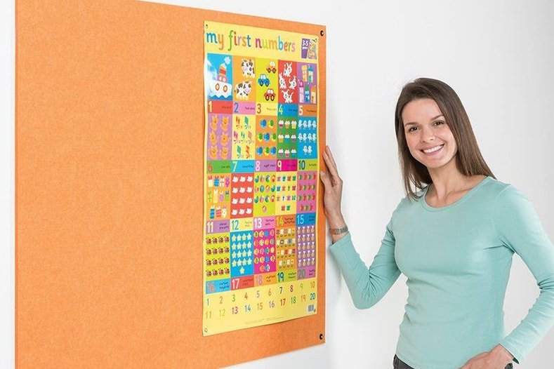 Woman smiling in front of children's notice board