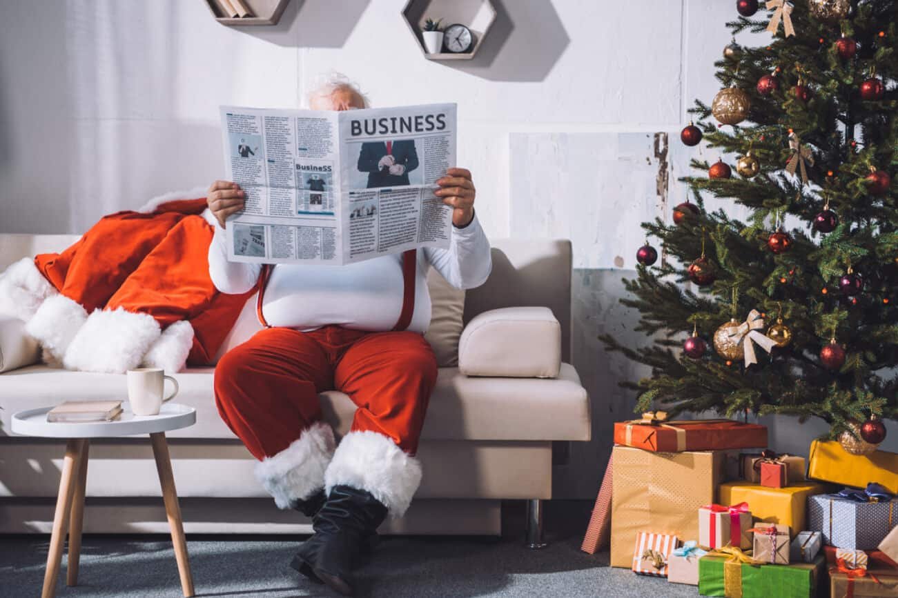 Santa Claus reading newspaper