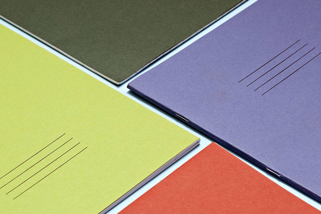 Close up of coloured exercise books